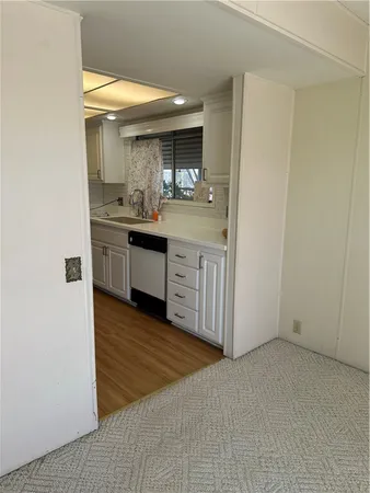 a kitchen with a refrigerator a stove and a wooden floor