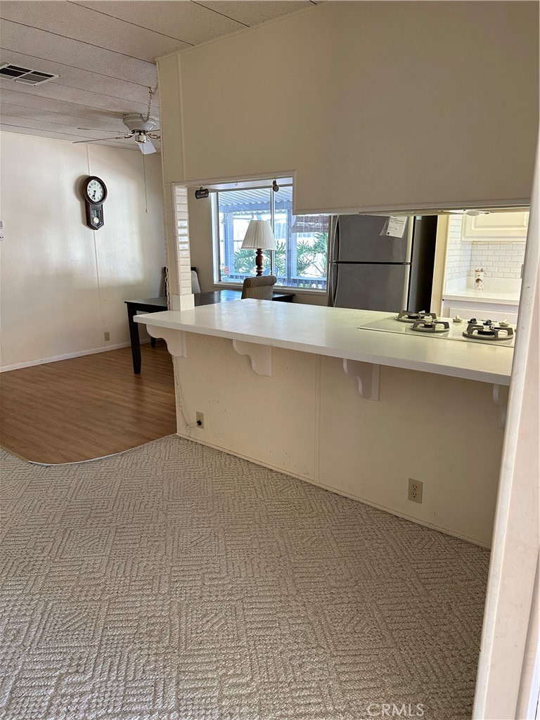 33853 Plowshare Road Wildomar, CA 92595 - Photo 23 of 25 a living room with kitchen island a sink and a stove