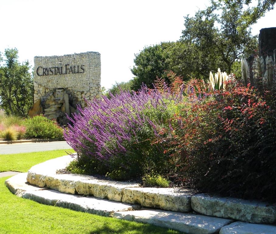 1765 Rowdy Loop, Unit 47 Leander, TX 78641 - Photo 36 of 39 Lush landscaping and stone masonry frame the entrance to this desirable community.