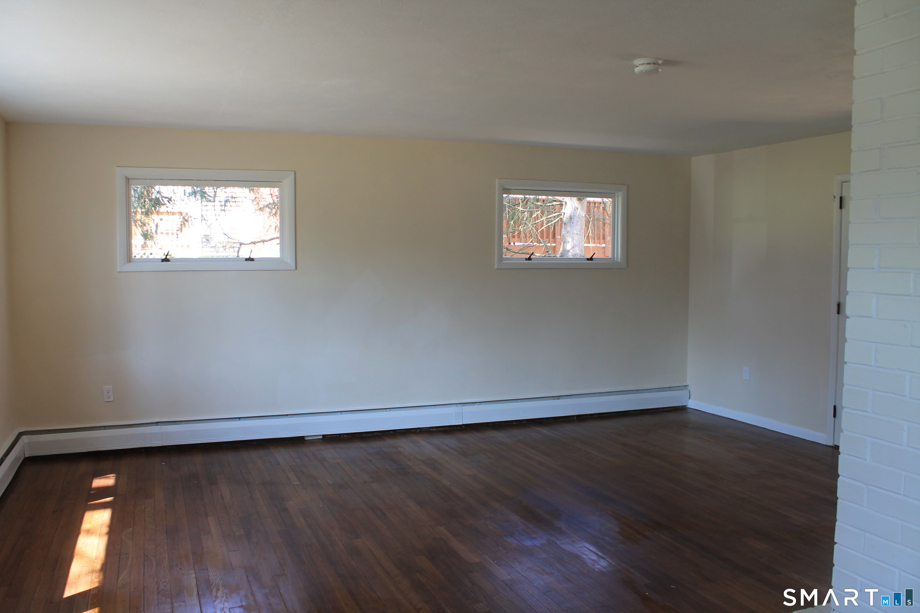 134 Sunset Street Windsor Locks, CT 06096 - Photo 14 of 23 a view of an empty room with wooden floor and a window