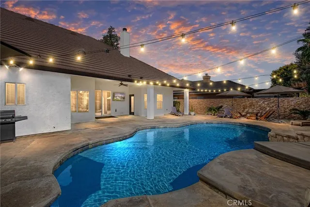 a view of a swimming pool with an outdoor seating