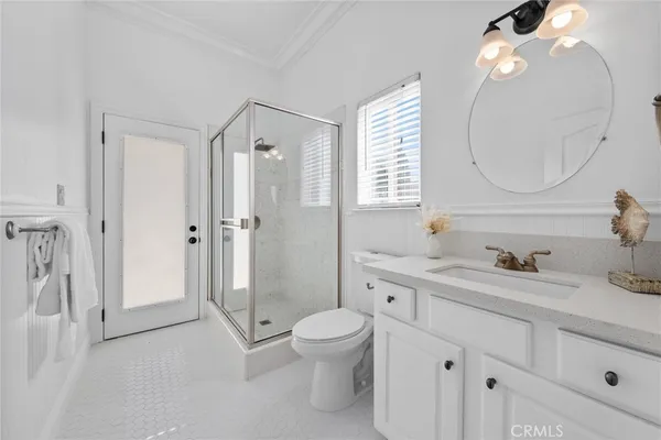 a bathroom with a double vanity sink mirror and shower