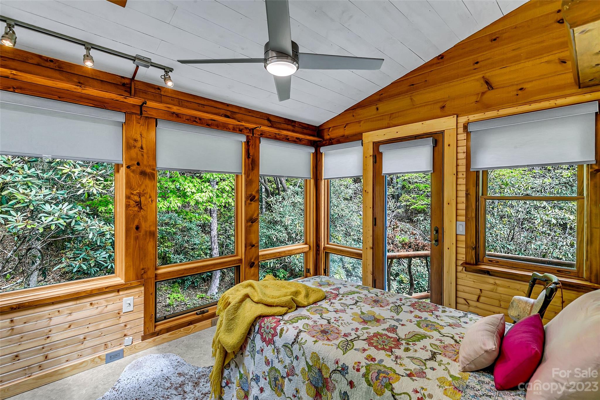 449 Old Powell Road Brevard, NC 28712 - Photo 12 of 48 a bed sitting in a bedroom next to a window