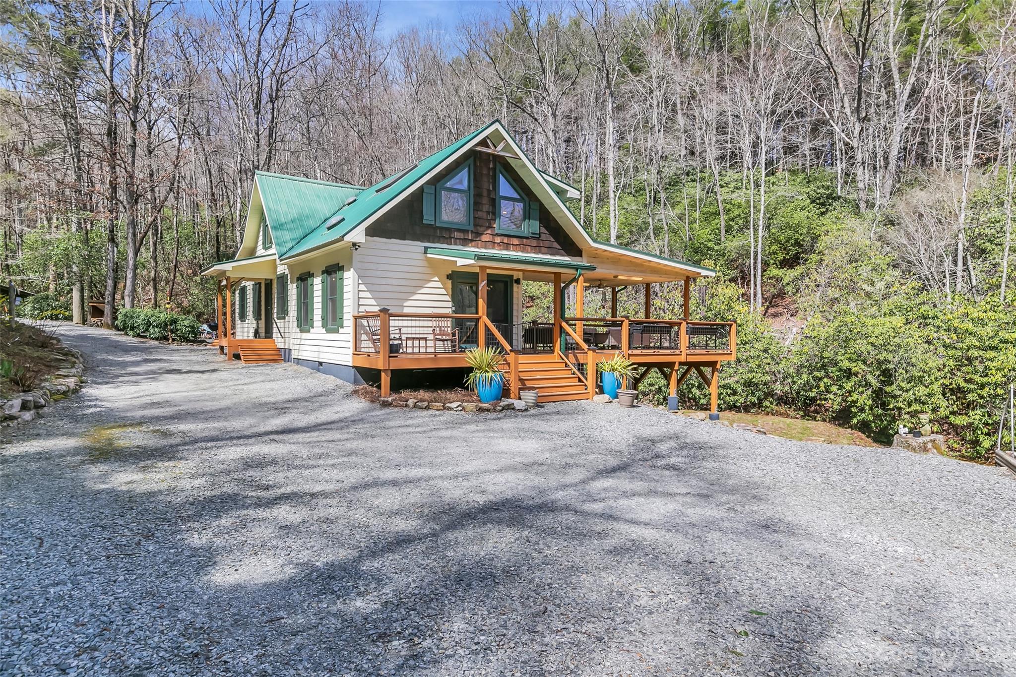 449 Old Powell Road Brevard, NC 28712 - Photo 40 of 48 a view of a house with a small yard and large trees