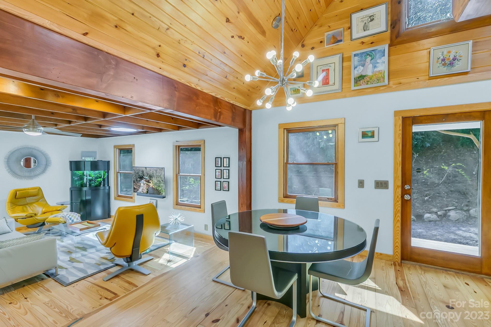 449 Old Powell Road Brevard, NC 28712 - Photo 6 of 48 a view of a dining room with furniture a chandelier and wooden floor