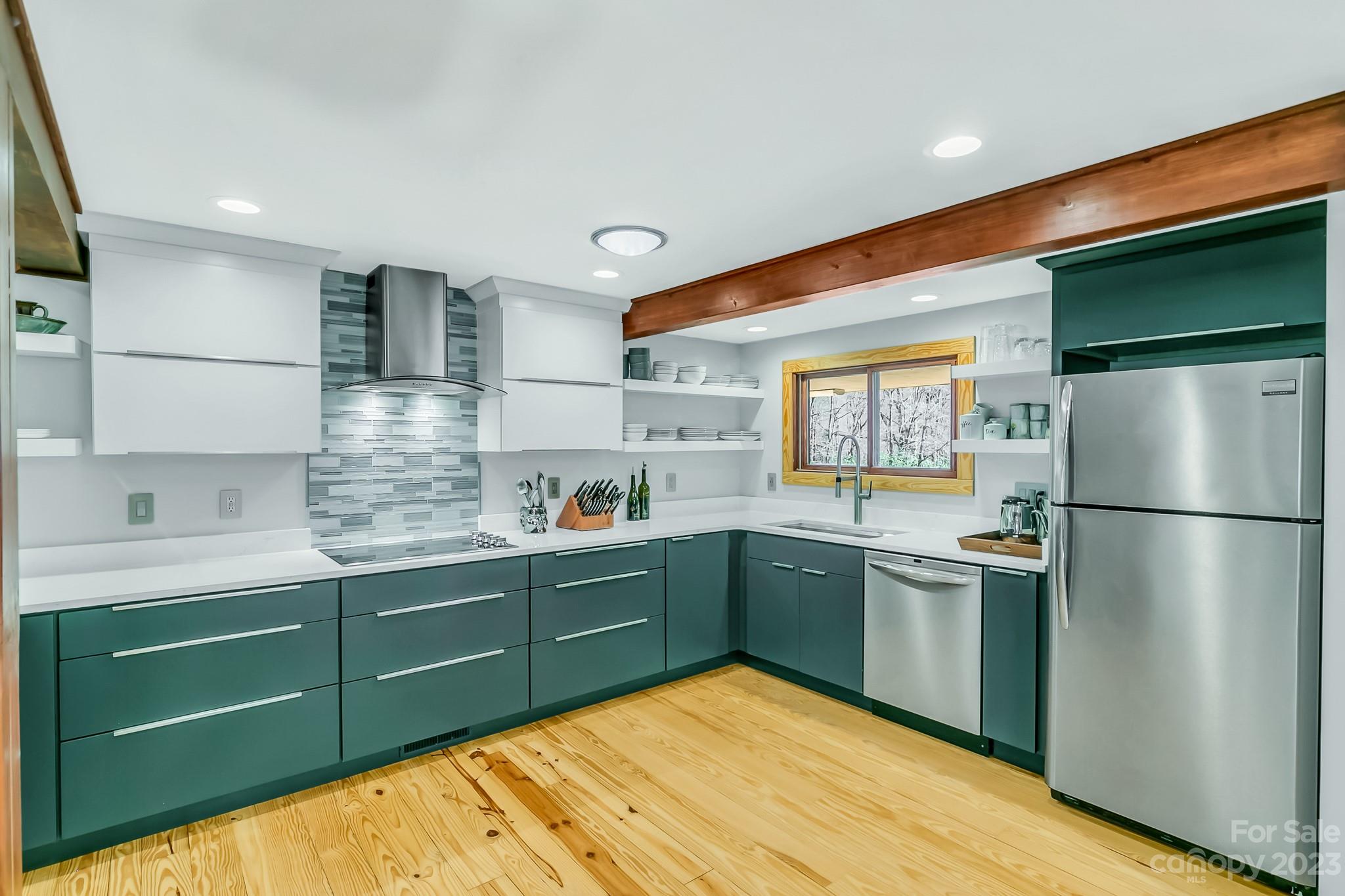 449 Old Powell Road Brevard, NC 28712 - Photo 8 of 48 a kitchen with kitchen island a sink stainless steel appliances and cabinets