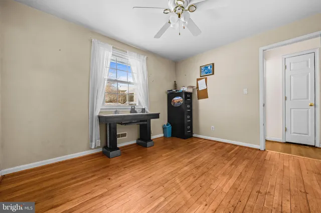 a view of a room with wooden floor and workspace