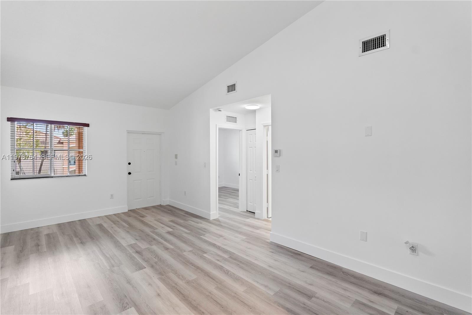 2930 Southeast 12th Road, Unit 20431 Homestead, FL 33035 - Photo 14 of 33 an empty room with wooden floor and windows