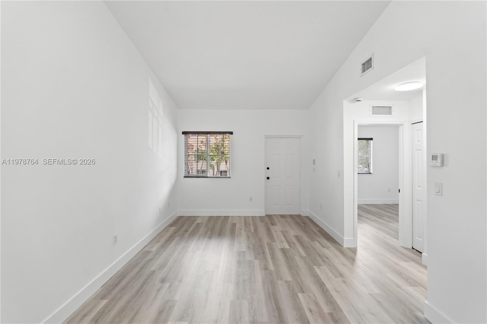 2930 Southeast 12th Road, Unit 20431 Homestead, FL 33035 - Photo 15 of 33 an empty room with wooden floor and windows