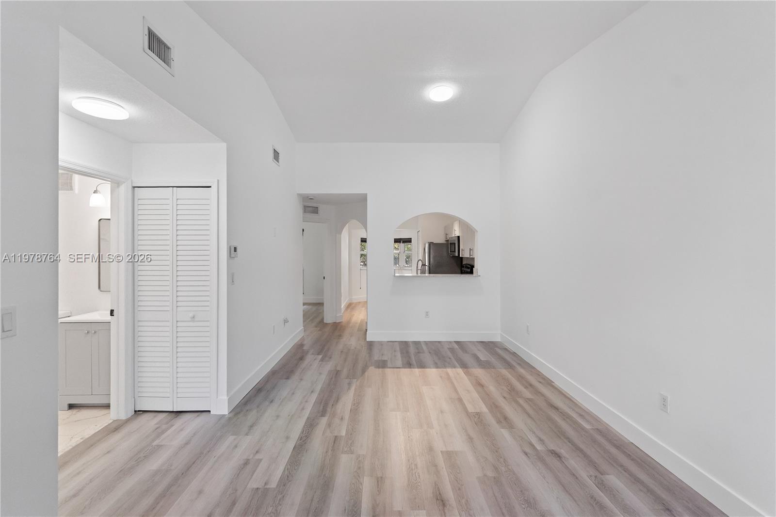 2930 Southeast 12th Road, Unit 20431 Homestead, FL 33035 - Photo 2 of 33 a view of a room with wooden floor and a hallway