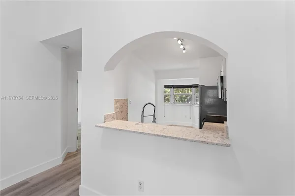 a kitchen with granite countertop a sink and a stove top oven