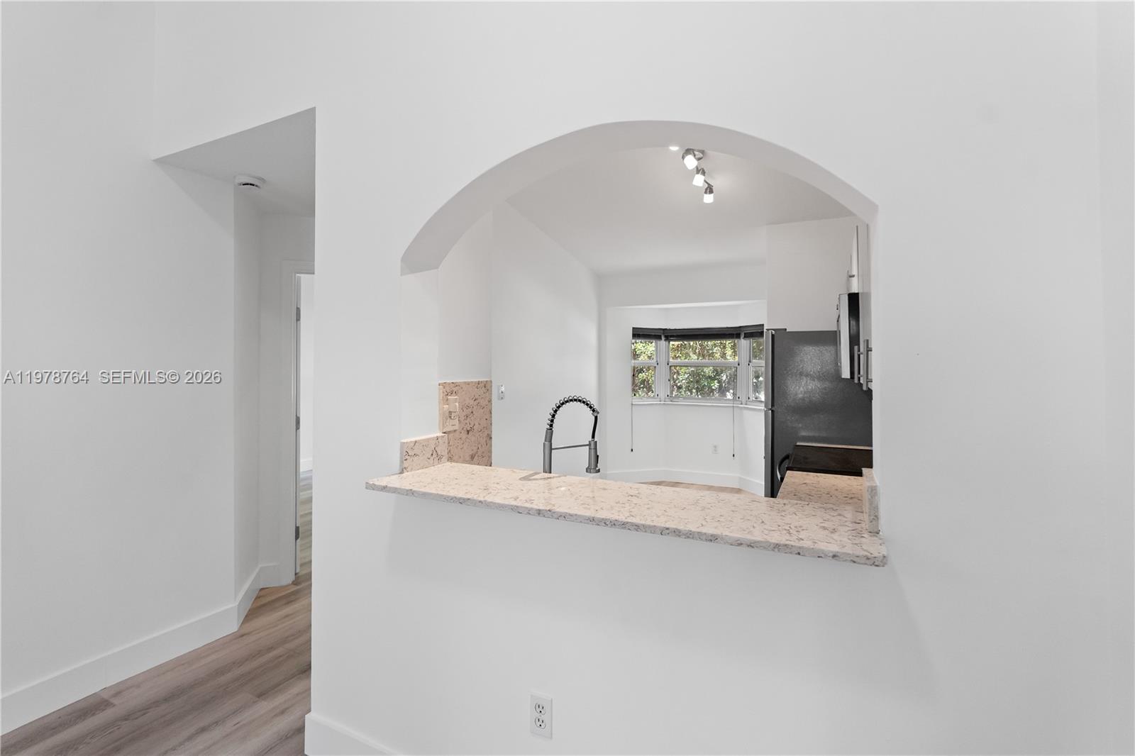 2930 Southeast 12th Road, Unit 20431 Homestead, FL 33035 - Photo 3 of 33 a kitchen with granite countertop a sink and a stove top oven