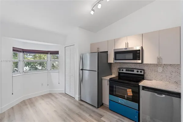 a kitchen with a refrigerator stove and microwave