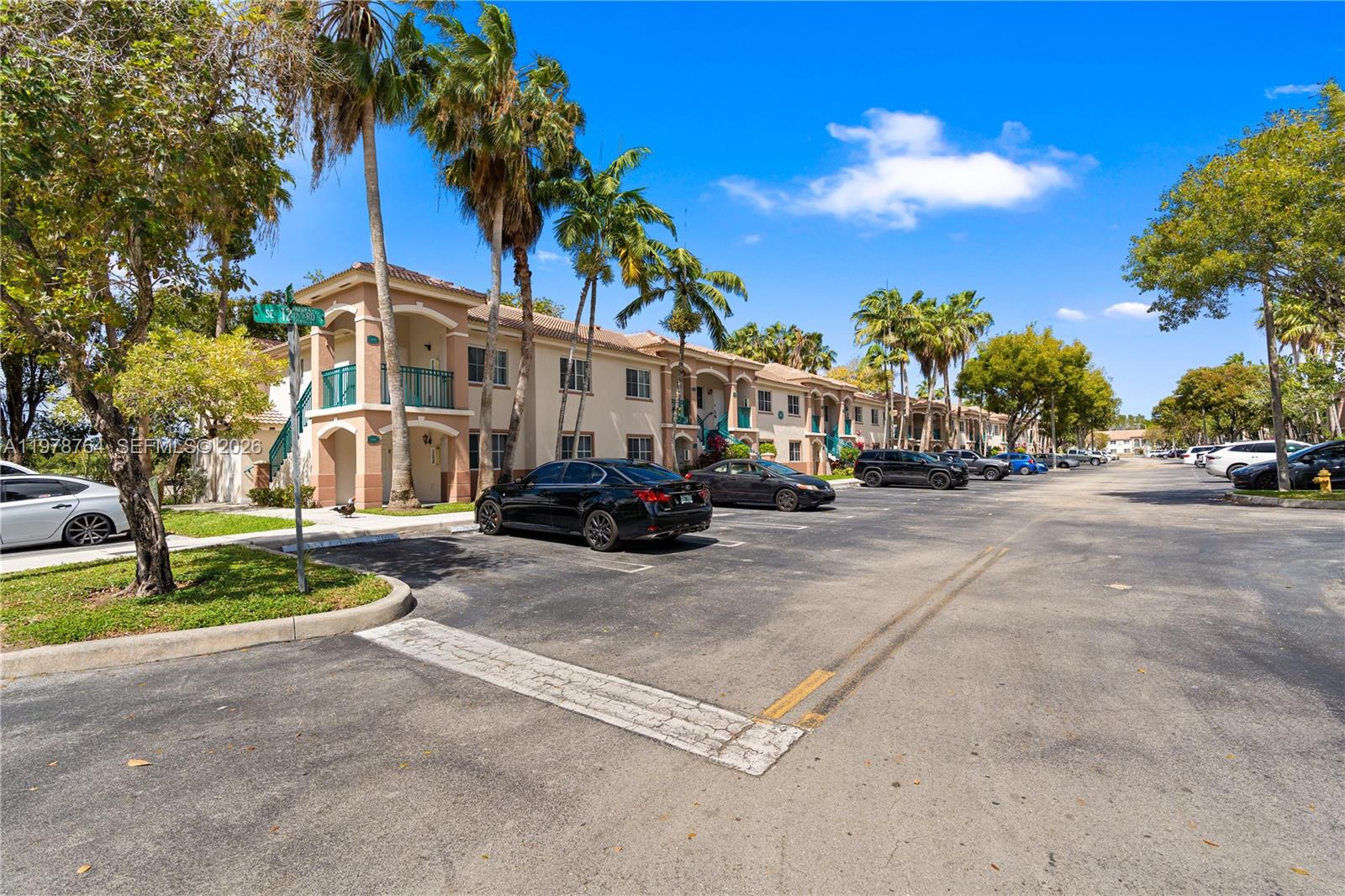 2930 Southeast 12th Road, Unit 20431 Homestead, FL 33035 - Photo 9 of 33 a view of a street with cars parked