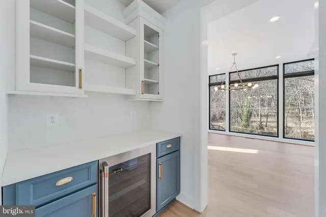 a view of a kitchen island a sink and dishwasher with wooden floor