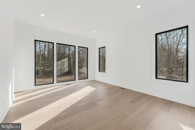 a view of hallway with wooden floor