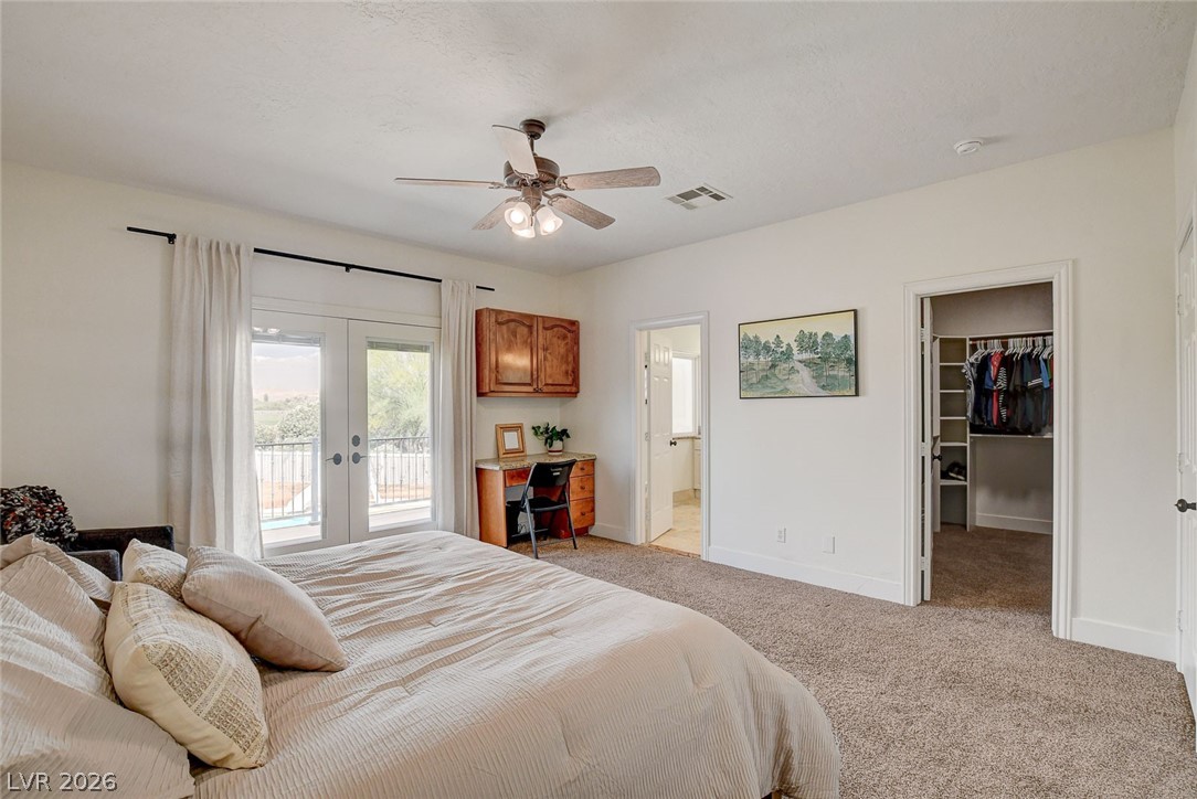 4362 Thistle Street Logandale, NV 89021 - Photo 26 of 99 Step out to the balcony from this well-lit primary bedroom featuring soft carpeting and a walk-in closet.