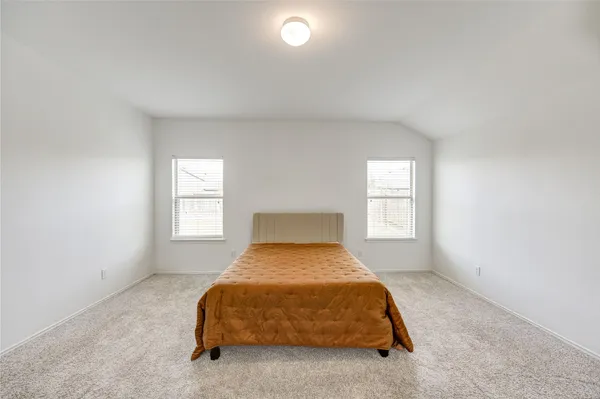a bedroom with a bed and a night stand