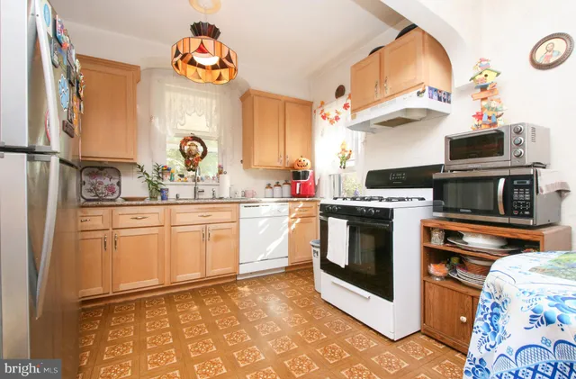 a kitchen with a sink stove and refrigerator