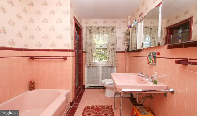 a bedroom with a bed and a dresser in it