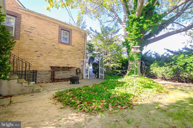 a living room with furniture a fireplace and a window