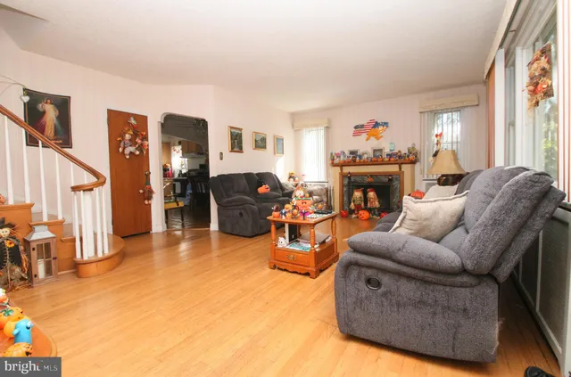 a living room with furniture a fireplace and a window