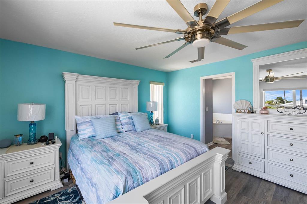 4464 Neptune Drive Hernando Beach, FL 34607 - Photo 18 of 47 a bedroom with a large bed and a dresser