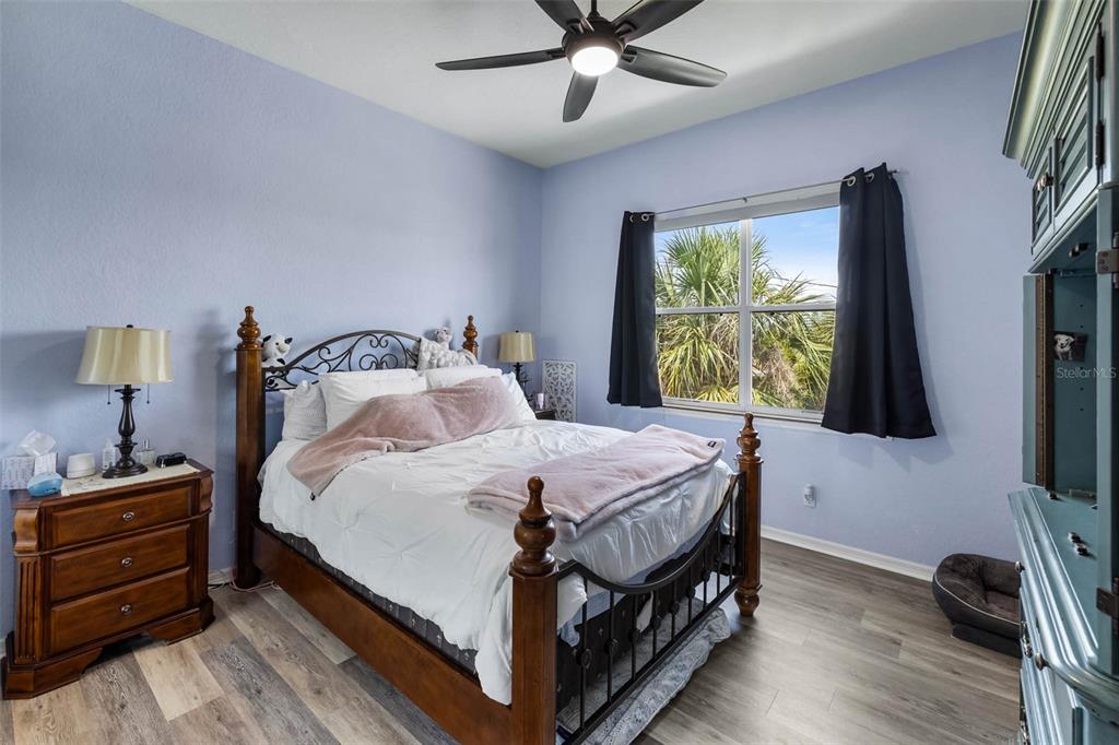 4464 Neptune Drive Hernando Beach, FL 34607 - Photo 25 of 47 a bedroom with a bed a flat screen tv and a window