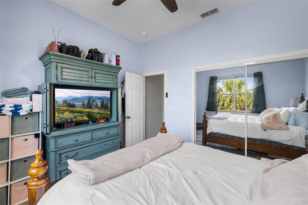 4464 Neptune Drive Hernando Beach, FL 34607 - Photo 26 of 47 a bedroom with a bed and a flat screen tv