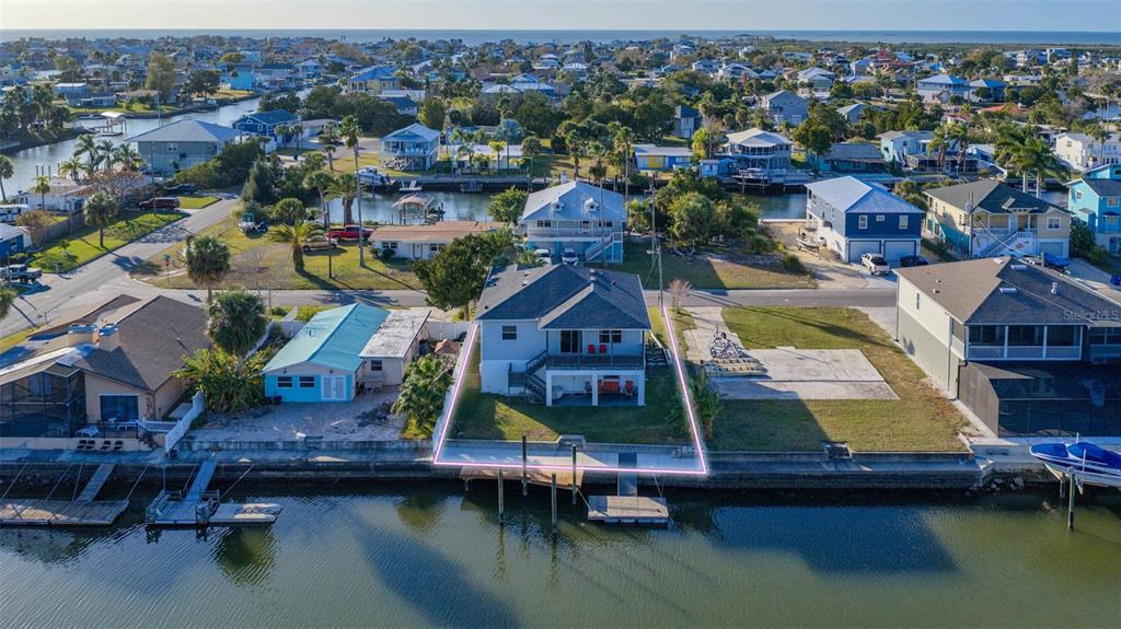 4464 Neptune Drive Hernando Beach, FL 34607 - Photo 3 of 47 an aerial view of residential houses with outdoor space