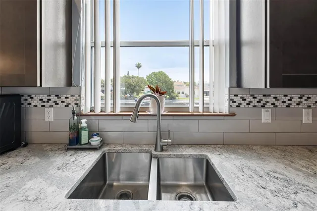 a bedroom with a bed a flat screen tv and a window