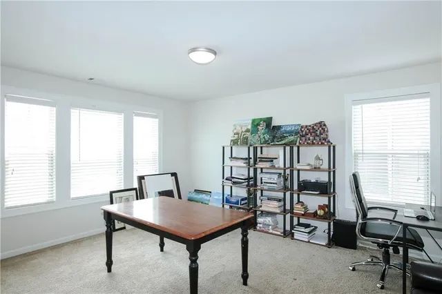 a view of a workspace with furniture and a window