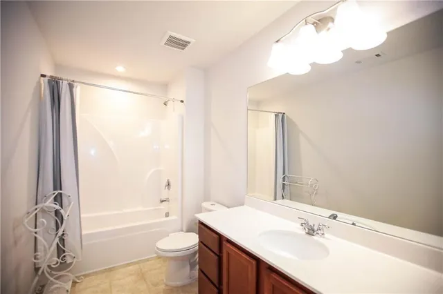 a bathroom with a bathtub shower sink and toilet