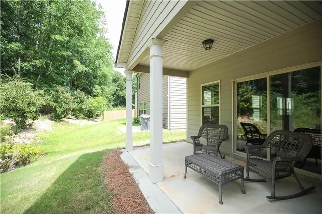 a backyard of a house with table and chairs