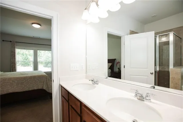 a bathroom with a double vanity sink and a mirror