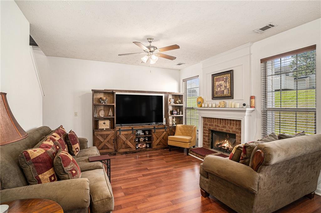 10897 Paladin Drive Hampton, GA 30228 - Photo 1 of 32 a living room with furniture a fireplace and a flat screen tv