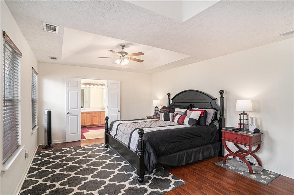 10897 Paladin Drive Hampton, GA 30228 - Photo 17 of 32 a bedroom with a bed and wooden floor