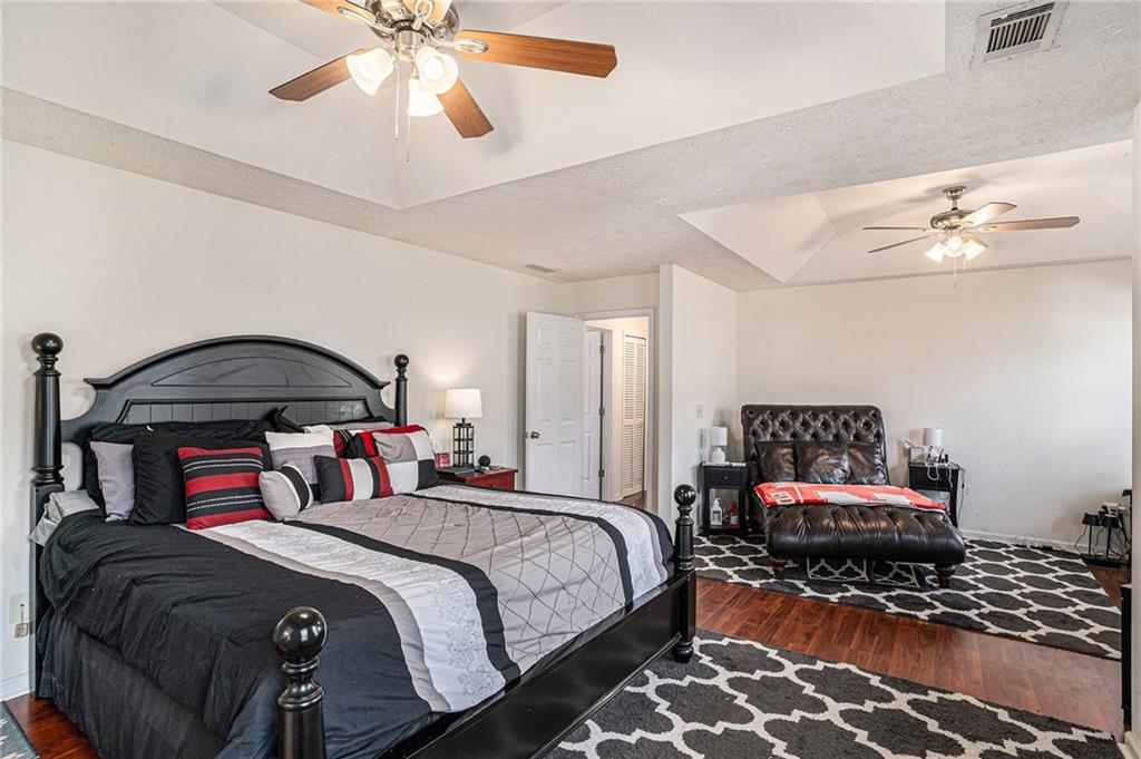 10897 Paladin Drive Hampton, GA 30228 - Photo 19 of 32 a bedroom with a bed and lamp