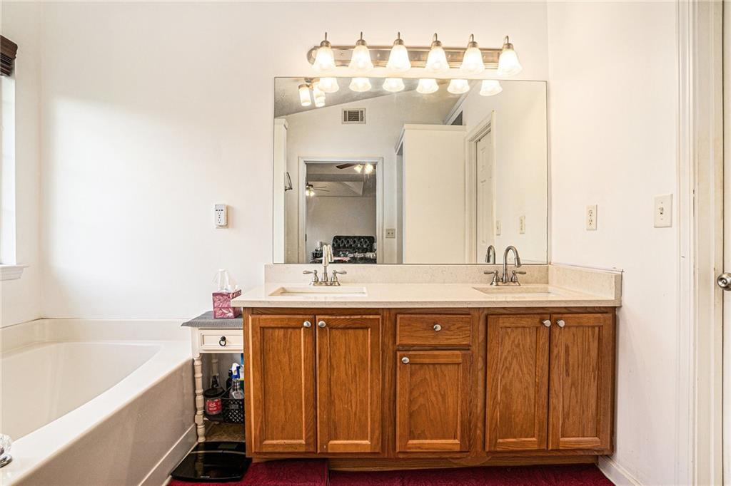 10897 Paladin Drive Hampton, GA 30228 - Photo 20 of 32 a bathroom with a sink and a mirror