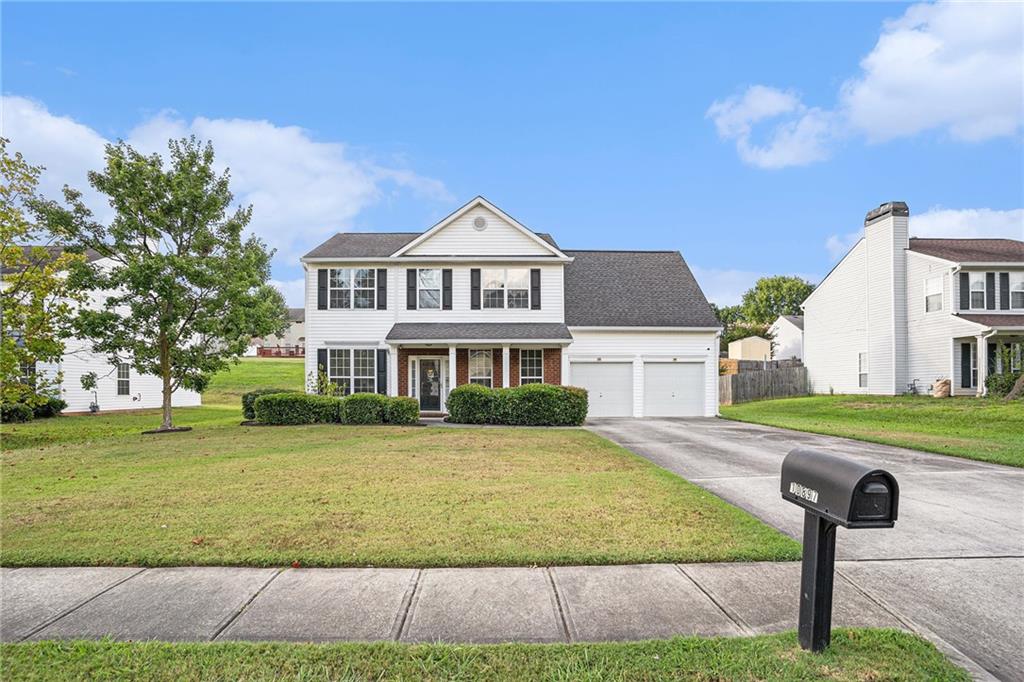 10897 Paladin Drive Hampton, GA 30228 - Photo 3 of 32 a front view of a house with garden
