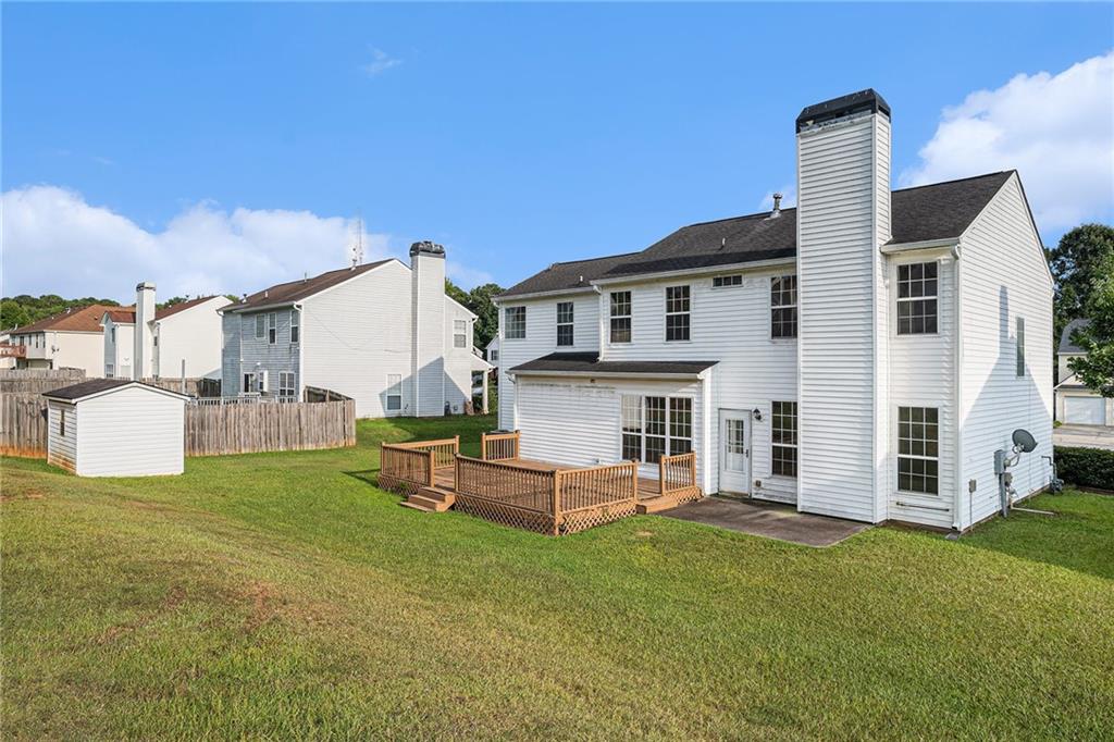 10897 Paladin Drive Hampton, GA 30228 - Photo 32 of 32 a front view of a house with a garden and yard