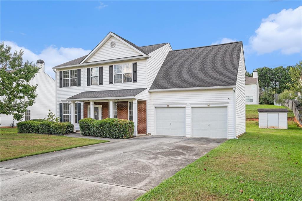 10897 Paladin Drive Hampton, GA 30228 - Photo 4 of 32 a front view of a house with a garden