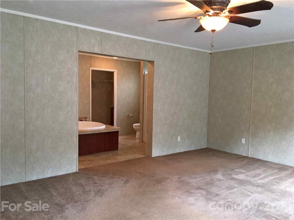 3853 State Rd S-29-330 Lancaster, SC 29720 - Photo 22 of 39 a view of an empty room and a chandelier fan