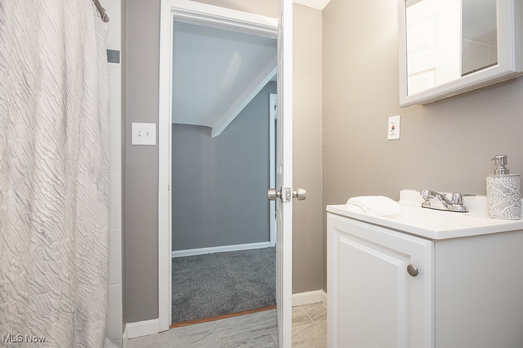 1547 Genesee Road South Euclid, OH 44121 - Photo 18 of 36 Full bathroom with vanity, a shower with curtain, lofted ceiling, and baseboards