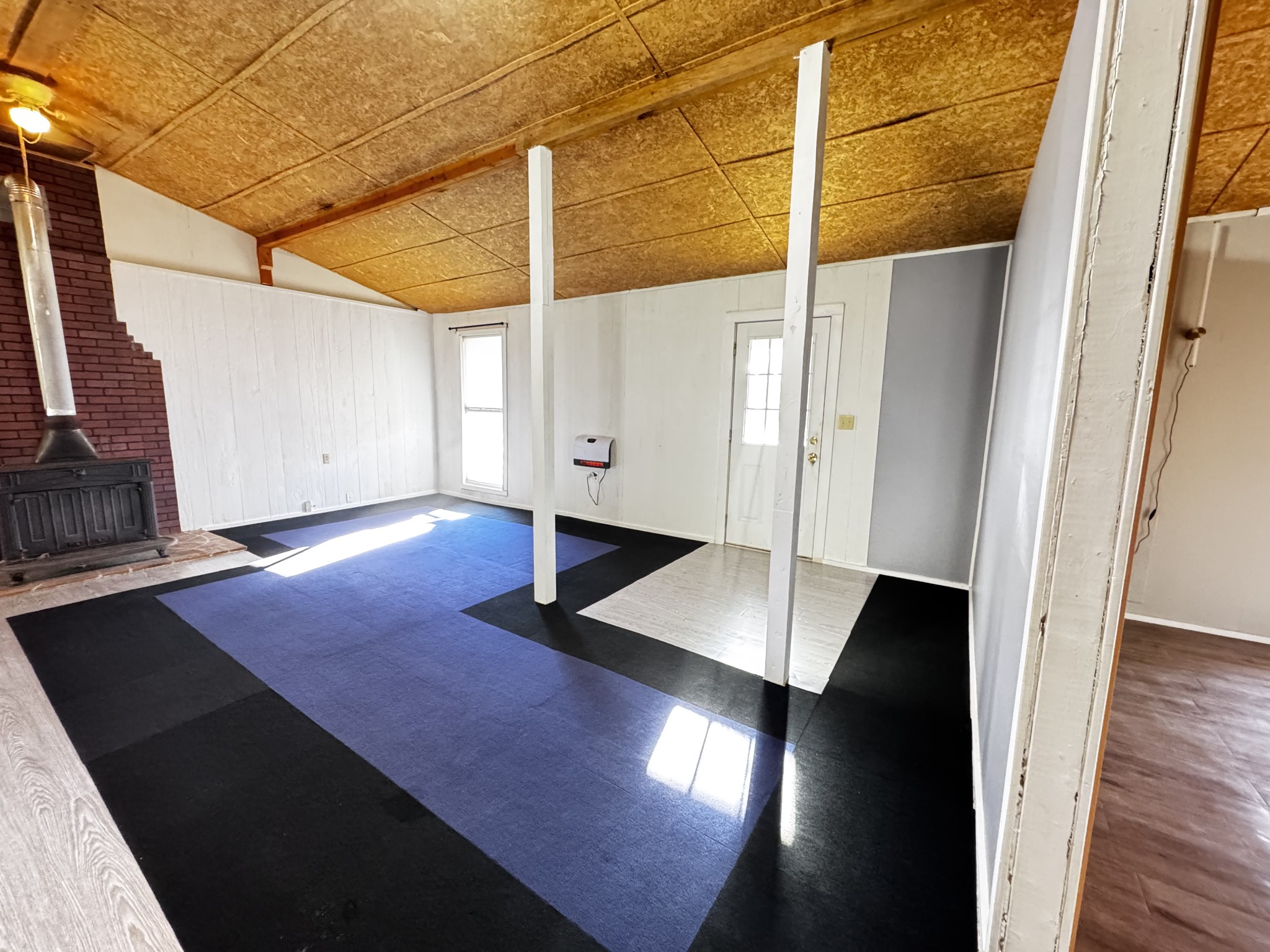 829 Highway 399 Palmer, TN 37365 - Photo 11 of 18 a view of an empty room with wooden floor and a window