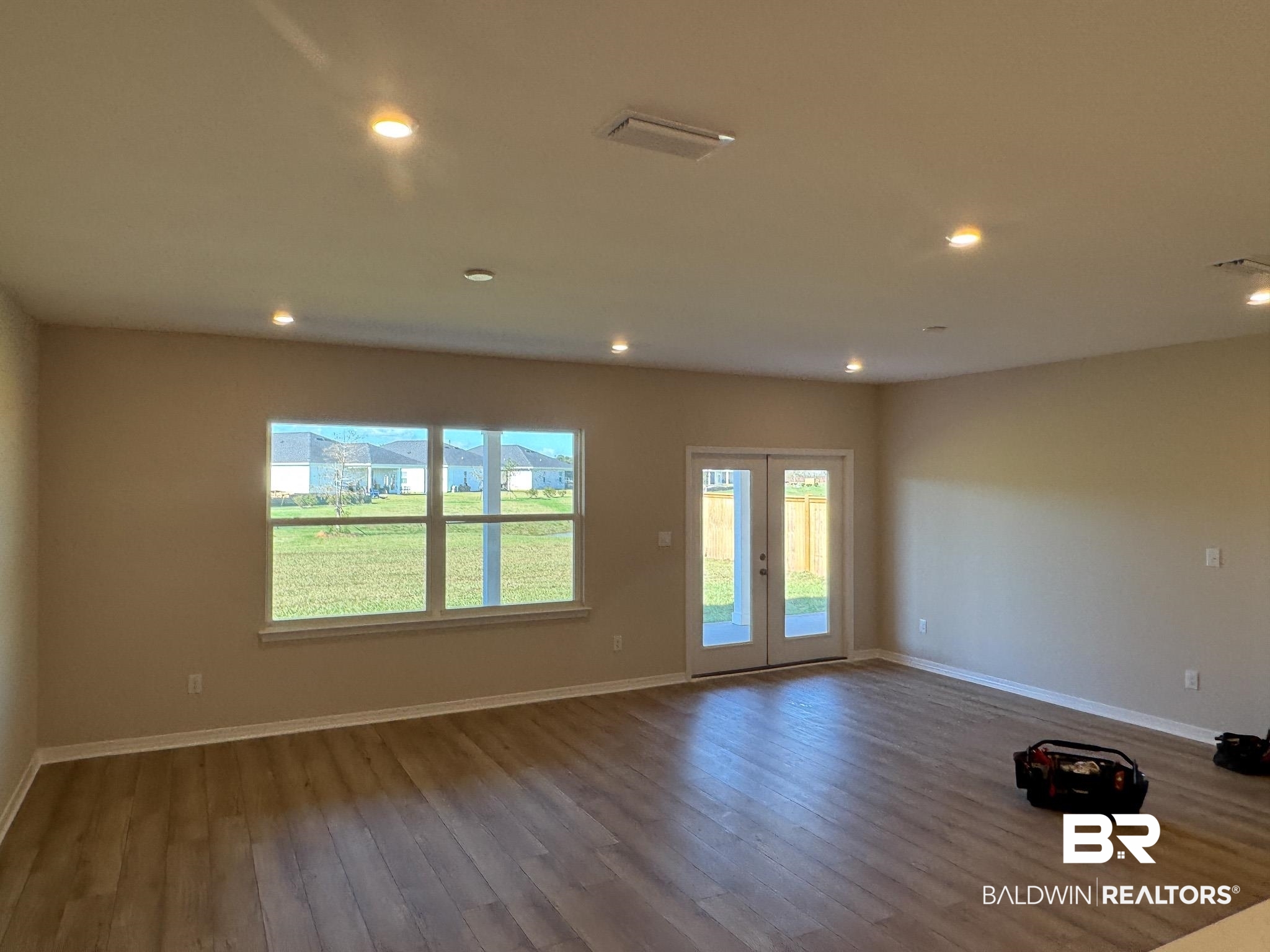 24026 Shadowridge Drive Daphne, AL 36526 - Photo 2 of 11 Unfurnished room with french doors and hardwood / wood-style flooring