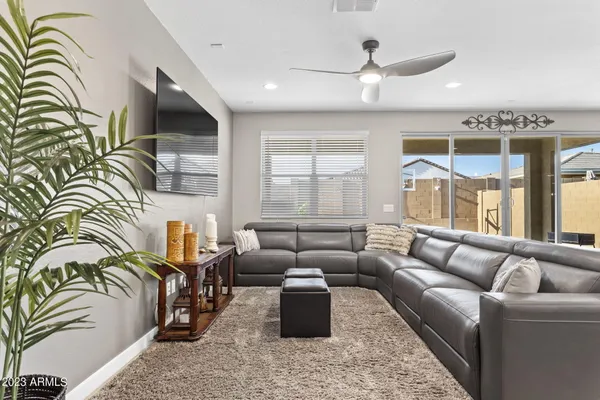 a bedroom with a bed and a couch next to a window