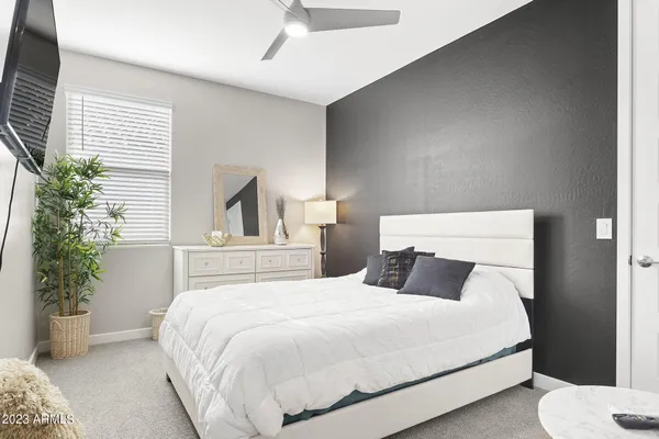 a bedroom with a large bed and a tv