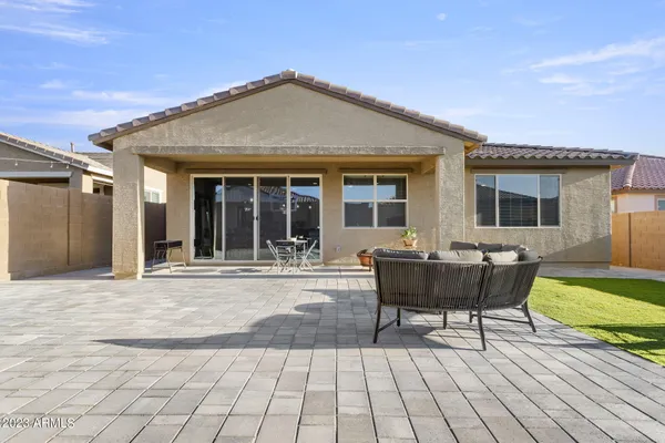 a view of a patio with a dining table chairs and couches with sky view