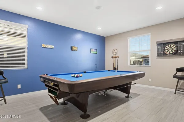 a room with pool table and window